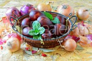 Easter eggs in wicker basket and yellow and red onion