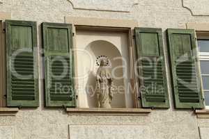 Statuette of the Virgin Mary in the window