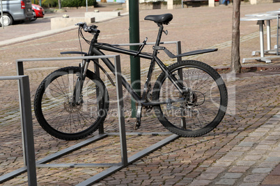 bike is fastened to rack of street fence