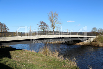 Bridge over a small river in spring