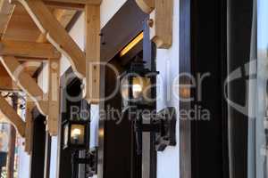 Glowing street lamps on the facade of houses