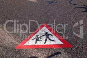 Children on the road, sign painted on the asphalt