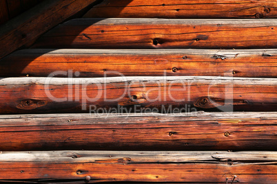 Wooden wall of a house made of thick logs