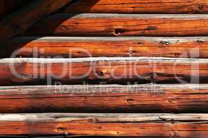 Wooden wall of a house made of thick logs