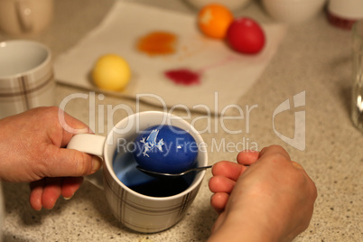 Painting Easter eggs. Painting eggs for easter holiday celebration.