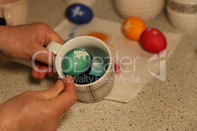 Painting Easter eggs. Painting eggs for easter holiday celebration.