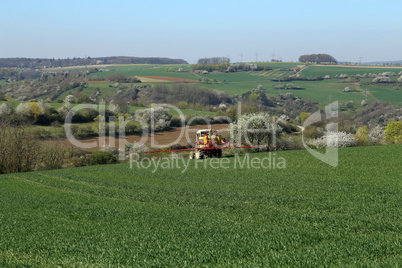 Working agricultural machinery in the field in the spring