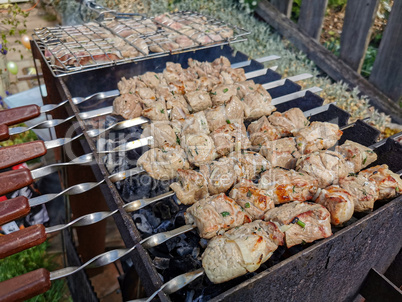 Meat on skewers is fried on the grill