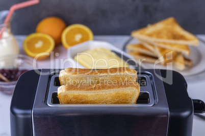 Slices of toast coming out of the toaster for healthy breakfast