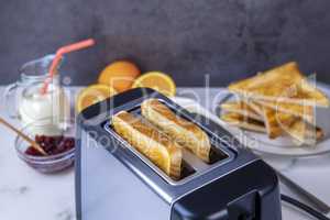 Slices of toast coming out of the toaster for healthy breakfast