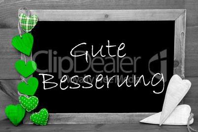 Balckboard With Green Heart Decoration, Text Gute Besserung Means Get Well Soon