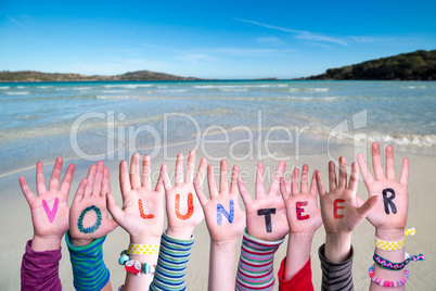 Children Hands Building Word Volunteer, Ocean Background