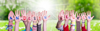 Kids Hands Holding Word Anderen Helfen Means Help Others, Grass Meadow