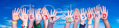 Kids Hands Holding Word Bleibt Gesund Means Stay Healthy, Blue Sky