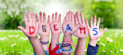 Kids Hands Holding Word Dreams, Grass Meadow