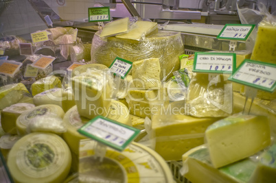 Cheeses on sale on the counter of the grocery store
