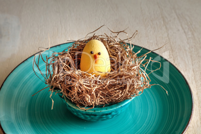 Chocolate egg in an Easter basket nest