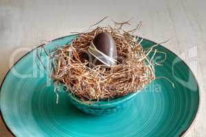 Chocolate egg in an Easter basket nest