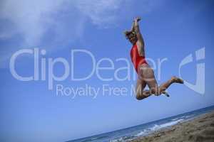 Rebel blonde girl jump in swimsuit