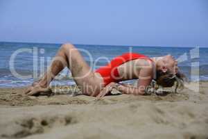 Rebel blonde girl poses lying in swimsuit