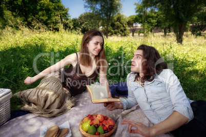 Picnic at the park, young couple of friends, boy and girl.