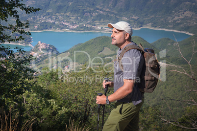 hiker in the mountains, against the backdrop a beautiful lake.