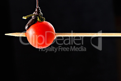 Cherry tomato pricked on a wooden skewer