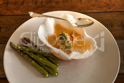 Seafood meal of Lobster bisque soup in a seashell bowl