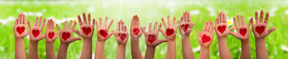 Children Hands With Heart Symbol, Grass Meadow As Background