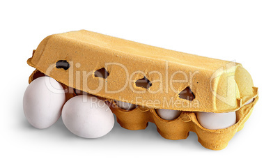 Closed egg tray and two eggs in front