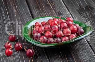 Red gooseberries on a dark table