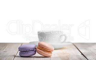 Two macaroons with a cup coffee