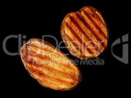 Two slices of grilled potatoes rotated