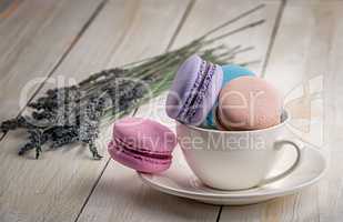 Macaroons in white cup with lavender