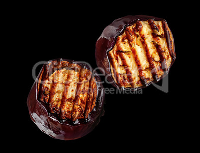 Two pieces of grilled eggplant rotate