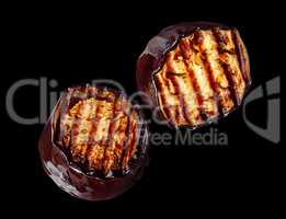 Two pieces of grilled eggplant rotate