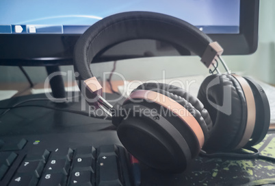 Stereo headphones on the keyboard of a computer