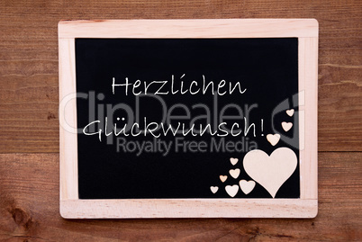 Balckboard With Wooden Heart Decoration, Text Glueckwunsch Means Congratulations