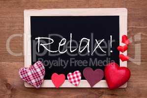 Balckboard With Red Heart Decoration, Text Relax, Wooden Background