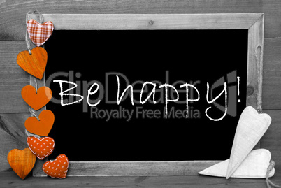 Balckboard With Orange Heart Decoration, Text Be Happy, Gray Wooden Background