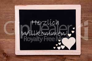 Balckboard With Wooden Heart Decoration, Text Willkommen Means Welcome