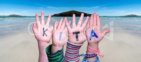 Children Hands Building Word KITA Means Kindergarden, Ocean Background