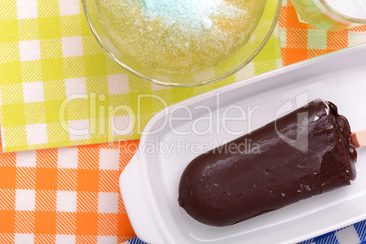 Chocolate ice cream on white plate and green ice. top view