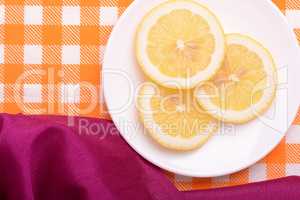 Lemon sliced lies on a plate shaped