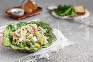 Salad of vegetables, green onions and crab sticks