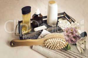 Massage brush made of natural wood and natural bristles and cosmetics.