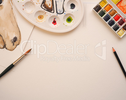 Blank watercolor paper sheet with utensils