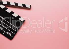 Clapboard on a pink background, movie concept