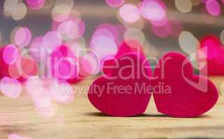 Small wooden hearts with pink bokeh effects
