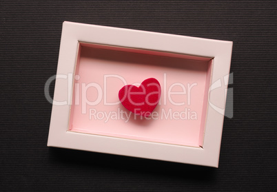 Red wooden heart shape in a gift box